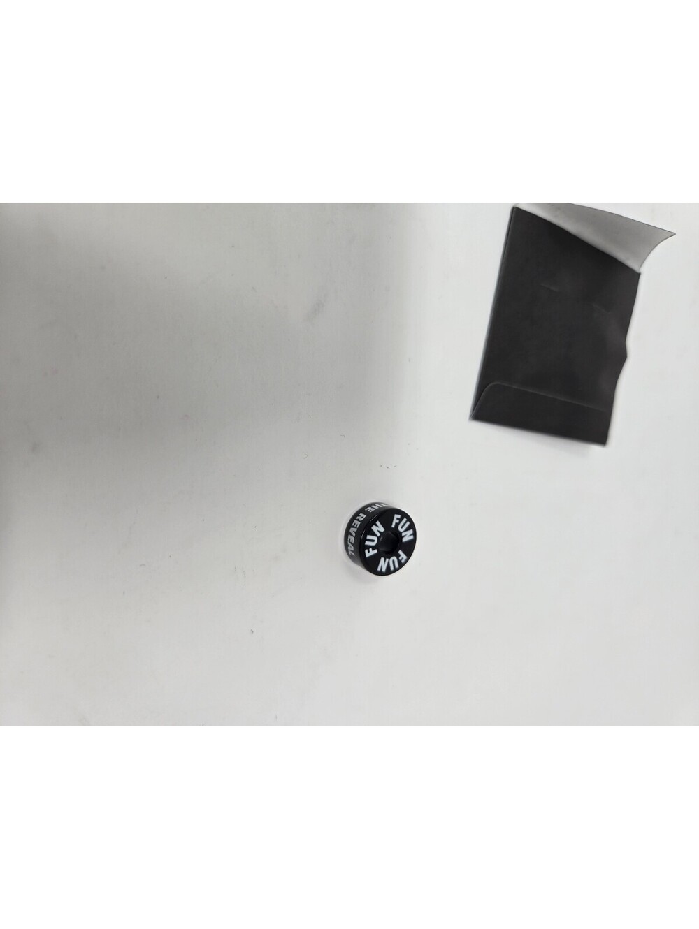 Fun Brand Black Button Pin with 'FUN' Text and 'The Reveal' Sleeve